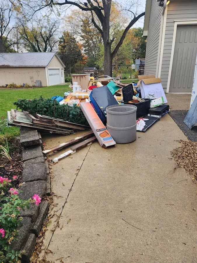 Dumpster being loaded with debris for Estate Cleanout Dumpster Rental in Peoria